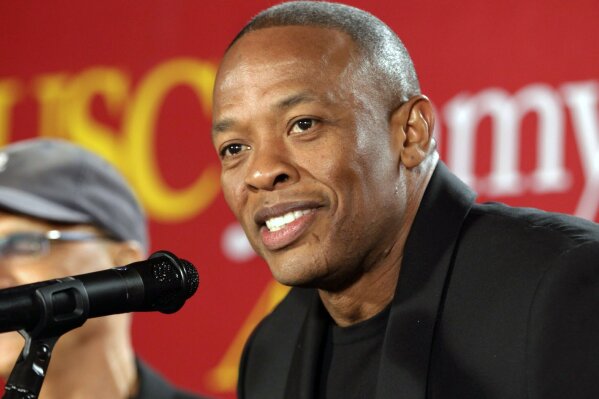 FILE - This May 15, 2013 file photo shows hip-hop mogul Dr. Dre as he announces a $70 million dollar donation to create the new "Jimmy Iovine and Andre Young Academy for Arts and Technology and Business Innovation," at the University of Southern California, in Santa Monica, Calif. Music mogul Dr. Dre was back at home Saturday, Jan 16, 2021, after being treated at a Los Angeles hospital for a reported brain aneurysm. Peter Paterno, an attorney for the rapper and producer, said Dre was home but offered no other details in an email exchange Saturday.  (AP Photo/Damian Dovarganes, File)