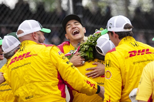 Alex Palou, center, of Spain, celebrates with his crew after winning the Indianapolis 500 auto race at Indianapolis Motor Speedway in Indianapolis, Sunday, May 25, 2025. (AP Photo/AJ Mast)