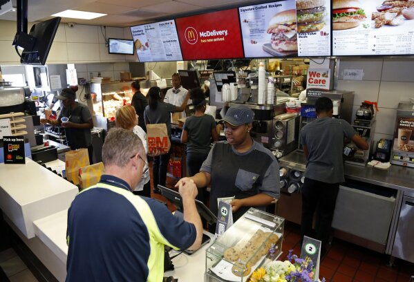 FILE - In this July 18, 2018, file photo a customer gets his coffee at a McDonald's restaurant in Pittsburgh. In a very limited test in Canada, McDonald's said Thursday, Sept. 26, 2019, that it's introducing the PLT, or the plant, lettuce and tomato burger. It will be available for 12 weeks in 28 restaurants in Southwestern Ontario by the end of the month. (AP Photo/Gene Puskar, File)