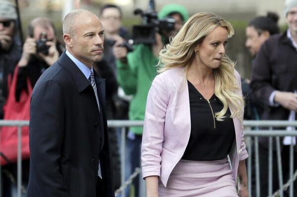 CORRECTS YEAR OF SENTENCING TO 2022, NOT 2020 - FILE - Stormy Daniels and her attorney Michael Avenatti leave federal court in New York, on April 16, 2018. Avenatti was sentenced Thursday, June, 2, 2022, to four years in prison for cheating client Stormy Daniels, the porn actor who catapulted him to fame, of hundreds of thousands of dollars in book proceeds. (AP Photo/Seth Wenig, File)
