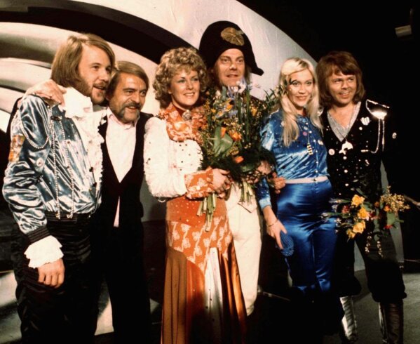 FILE - Members of Swedish group ABBA and close associates celebrate the victory of their song "Waterloo" in the Eurovision Song Contest in Brighton, England, April 6, 1974. Fans are celebrating 50 years since ABBA won its first big battle with “Waterloo.” A half century ago on Saturday, April 6, the Swedish quartet triumphed at the 1974 Eurovision Song Contest with the peppy love song. (AP Photo/File)