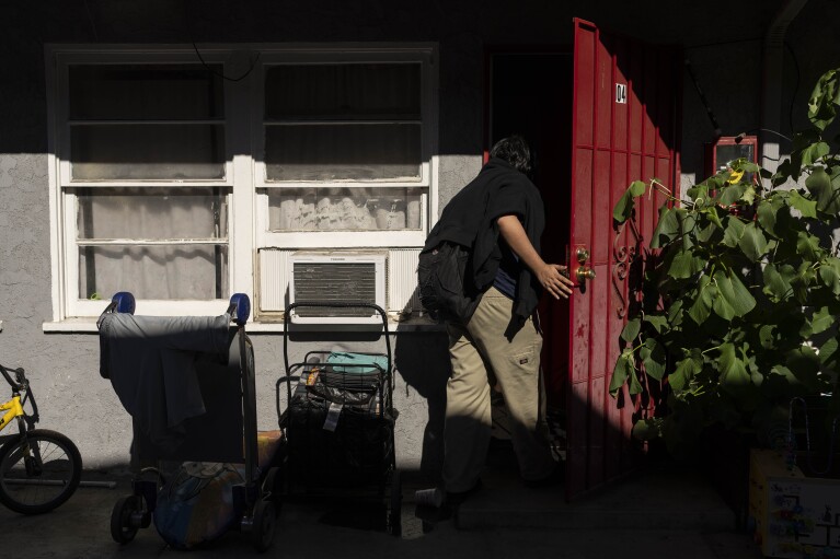 Deneffy Sánchez, 15, walks into a studio apartment his family shares with a roommate in Los Angeles, Tuesday, Aug. 29, 2023. Each community has its own set of circumstances that have conspired to sabotage young peoples' dreams during the COVID-19 crisis. In Los Angeles and much of California, housing insecurity has devastated children and teens' chance at recovery like nothing else. (AP Photo/Jae C. Hong)