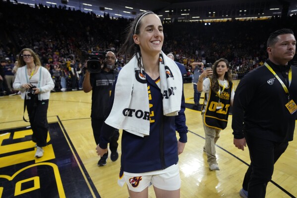 Indiana Fever guard Caitlin Clark, center, walks off the court after an exhibition women's basketball game against Brazil, Sunday, May 4, 2025, in Iowa City, Iowa. (AP Photo/Charlie Neibergall)