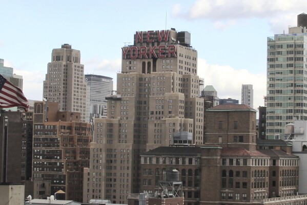 FILE - The New Yorker Hotel, center, is seen in New York, Nov. 8, 2013. A man who succeeded in using a New York City housing law to live rent-free in the iconic hotel has been charged with fraud after he claimed to own it. (AP Photo/Peter Morgan, File)