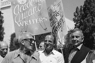 FILE - Oscar-winning writers, from left, Richard Brooks, Bo Goldman, and Gore Vidal join members of the Writers Guild of America during a massive picket outside the 20-Century Fox studios in Los Angeles on June 25, 1981. Goldman, who penned the Oscar-winning scripts to “One Flew Over the Cuckoo’s Nest” and “Melvin and Howard” and whose textured, empathy-rich screenplays made him one of Hollywood’s finest writers, has died. He was 90. Goldman died Tuesday in Helendale, Calif., his son-in-law, the director Todd Field, said. (AP Photo/ Wally Fong, File)