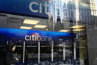 FILE - In this March 16, 2017, file photo, a customer enters a Citibank branch, in New York. Citigroup intentionally discriminated against Armenian Americans when they applied for credit cards, the Consumer Financial Protection Bureau said Wednesday, Nov. 8, 2023. (AP Photo/Mark Lennihan, File)