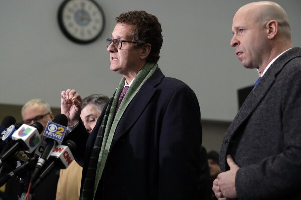 
              Attorney Todd Pugh, left, who represents ex-Officer Joseph Walsh, right speaks to reporters at the courthouse Thursday, Jan. 17, 2019, in Chicago. Former Detective David March, ex-Officer Joseph Walsh and Officer Thomas Gaffney, three Chicago police officers accused accused of trying to cover up the fatal shooting of Laquan McDonald by officer Jason Van Dyke in October 2014, were acquitted by a judge on Thursday.(AP Photo/Nam Y. Huh)
            