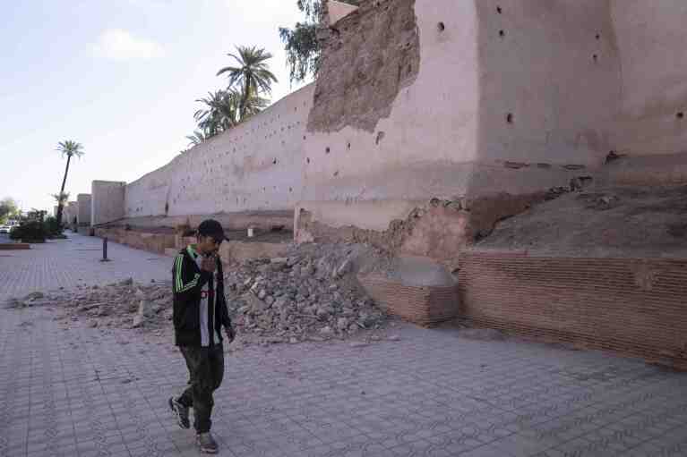 A man walks past a damaged wall of the historic Medina of Marrakech, after after an earthquake in Morocco, Saturday, Sept. 9, 2023. (AP Photo/Mosa'ab Elshamy)