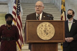 Maryland Gov. Larry Hogan, a Republican, announces a bipartisan budget agreement to allocate $3.9 billion in federal funding that the state expects to receive through the American Rescue Plan Act during a news conference with legislative leaders on Wednesday, March 31, 2021 in Annapolis. House Speaker Adrienne Jones, a Democrat, is standing left, and Senate President Bill Ferguson, a Democrat, is standing right.  (AP Photo/Brian Witte)