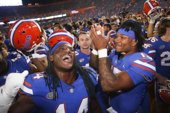 Florida linebacker Chief Borders (14) and quarterback Anthony Richardson (15) celebrate after an NCAA college football game against South Carolina, Saturday, Nov. 12, 2022, in Gainesville, Fla. (AP Photo/Matt Stamey)