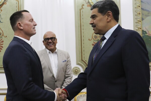 This photo released by Venezuela's presidential press office shows Venezuelan President Nicolas Maduro, right, shaking hands with Richard Grenell, President Donald Trump's special envoy, at Miraflores presidential palace in Caracas, Venezuela, Friday, Jan. 31, 2025. Behind is Jorge Rodriguez, president of the National Assembly. (Venezuela's presidential press office, via AP)