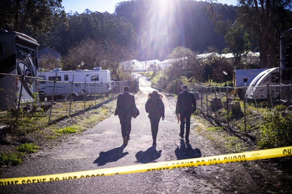 FILE - FBI officials walk towards the crime scene at Mountain Mushroom Farm, Tuesday, Jan. 24, 2023, in Half Moon Bay, Calif. A 66-year-old man was charged with killing seven people in back-to-back shootings at two mushroom farms. Between January 1 and June 30, the country recorded 28 mass killings, where at least four people were slain within 24 hours, not including the perpetrator. That's the the highest number of such massacres over a half-year period since data collection began in 2006. (AP Photo/Aaron Kehoe, File, File)