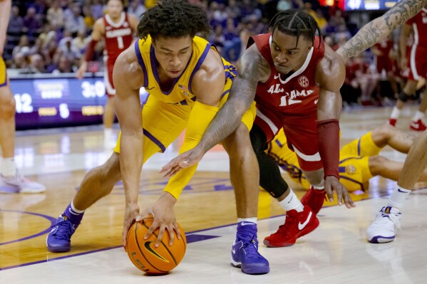 LSU guard Jalen Cook (3) and Alabama guard Latrell Wrightsell Jr. (12) battle for the ball during the first half of an NCAA college basketball game in Baton Rouge, La., Saturday, Feb. 10, 2024. (AP Photo/Matthew Hinton)