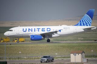 FILE - In this July 2, 2021 file photo, a United Airlines jetliner taxis down a runway for take off from Denver International Airport in Denver.  United Airlines has been fined, Friday, Sept. 24, 2021, $1.9 million over 25 delayed flights in which passengers were stuck on the ground for at least three hours. It's the largest fine ever imposed by the U.S. Transportation Department for such long delays.(AP Photo/David Zalubowski, file)