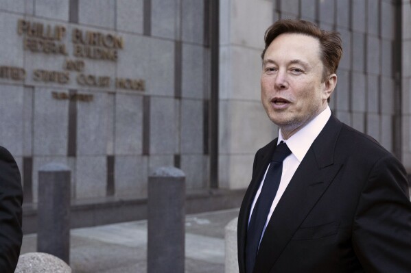 FILE - Elon Musk leaves the Phillip Burton Federal Building and United States Court House in San Francisco, Tuesday, Jan. 24, 2023. A federal appeals court Friday, July 21, said it will reconsider its March ruling that Musk unlawfully threatened employees with a loss of stock options in a 2018 Twitter post amid an organizing effort by the United Auto Workers union. (AP Photo/ Benjamin Fanjoy, File)