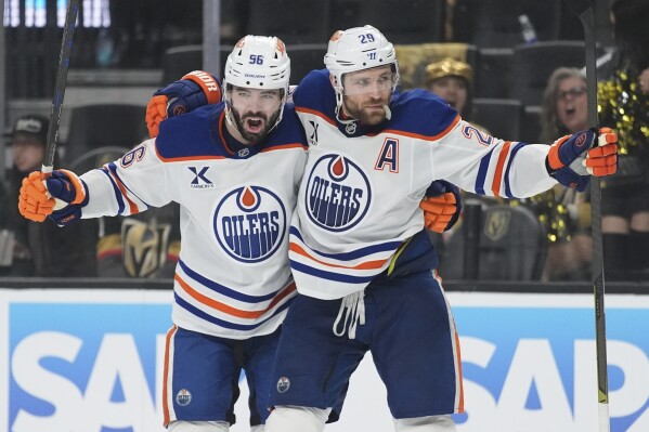 Edmonton Oilers center Leon Draisaitl (29) celebrates with teammates after scoring against the Vegas Golden Knights during the third period of Game 1 of a second-round NHL hockey playoff series Tuesday, May 6, 2025, in Las Vegas. (AP Photo/John Locher)