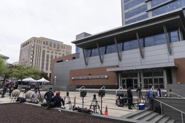 FILE - Members of the media gather outside the justice center in Wilmington, Del., Monday, April 17, 2023. Jurors were set to get their first look Tuesday at a voting machine company's $1.6 billion defamation lawsuit against Fox News in a trial that will test First Amendment protections and expose the network's role in spreading the lie of a stolen 2020 presidential election. (AP Photo/Matt Rourke, File)