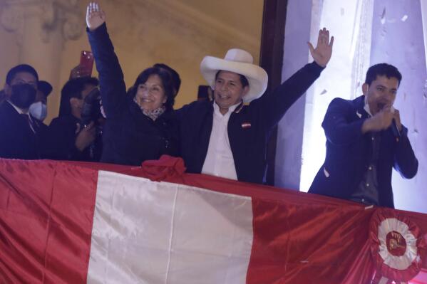 Pedro Castillo, center, celebrates with his running mate Dina Boluarte after being declared president-elect of Peru by election authorities, at his party´s campaign headquarters in Lima Peru, Monday, July 19, 2021. Castillo was declared president-elect more than a month after the elections took place and after opponent Keiko Fujimori claimed that the election was tainted by fraud. (AP Photo/Guadalupe Prado)