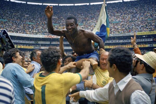 FILE - Brazil's Pele is hoisted on the shoulders of his teammates after Brazil won the World Cup final against Italy, 4-1, in Mexico City's Estadio Azteca, June 21, 1970. Pelé, the Brazilian king of soccer who won a record three World Cups and became one of the most commanding sports figures of the last century, died in sao Paulo on Thursday, Dec. 29, 2022. He was 82. (AP Photo, File)