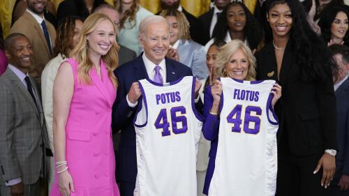 President Joe Biden and first lady Jill Biden are presented with jerseys by LSU women's basketball team captains Angel Reese, right, and Emily Ward, left, during an event to honor the 2023 NCAA national championship team in the East Room of the White House, Friday, May 26, 2023, in Washington. (AP Photo/Evan Vucci)