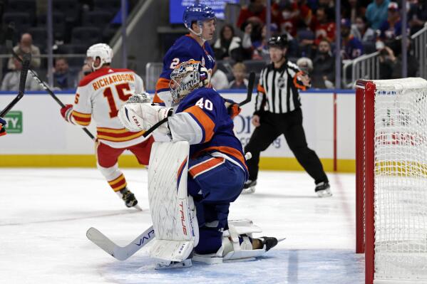 New York Islanders goaltender Semyon Varlamov (40) reacts after giving up a goal to Calgary Flames right wing Brad Richardson (15) in the first period of an NHL hockey game Saturday, Nov. 20, 2021, in Elmont, N.Y. (AP Photo/Adam Hunger)