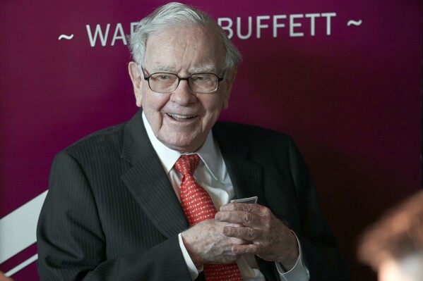 FILE - Warren Buffett, chairman and CEO of Berkshire Hathaway, smiles as he plays bridge following the annual Berkshire Hathaway shareholders meeting in Omaha, Neb., May 5, 2019. Buffett's company reported a $12.8 billion loss Saturday, Nov. 4, 2023, as the paper value of its investments fell, but the companies it owns — particularly the insurers — generally performed well.(AP Photo/Nati Harnik, File)