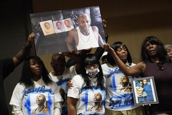 Family members of Byron Williams, from left, niece Teena Acree, brother Ellis Magee, niece Marcia Wells, sister Robyn Williams, and sister Tina Lewis-Stevenson hold up a picture of Byron Williams during a news conference, Thursday, July 15, 2021, in Las Vegas. The family of 50-year-old Byron Williams, whose death in Las Vegas police custody after a bicycle chase in 2019 was ruled a homicide, is suing the city and four officers they accuse of wrongful death and civil rights violations. (AP Photo/John Locher)
