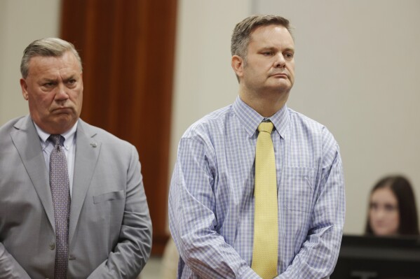 Chad Daybell, right, stands with defense lawyer John Prior as the jury's verdict in his murder trial is read at the Ada County Courthouse in Boise, Idaho, on Thursday, May 30, 2024. Daybell was convicted of killing his wife and his new girlfriend's two youngest kids in a strange triple murder case that included claims of apocalyptic prophesies, zombie children and illicit affairs. (AP Photo/Kyle Green, Pool)