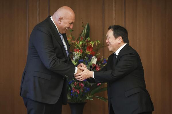 Italy's Defense Minister Guido Crosetto, left, shakes hands with Japan's Defense Minister Yasukazu Hamada during a bilateral meeting Thursday, March 16, 2023 in Tokyo, Japan. (Takashi Aoyama/Pool Photo via AP)