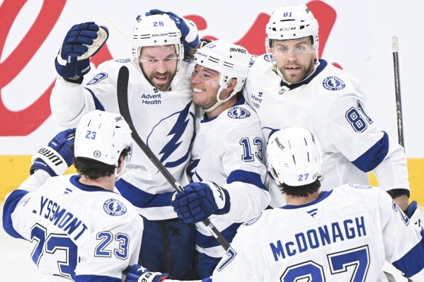 Tampa Bay Lightning's Zemgus Girgensons (28) celebrates with teammates after scoring against the Montreal Canadiens during the second period of an NHL hockey game in Montreal, Feb. 9, 2025. (Graham Hughes/The Canadian Press via AP, File)