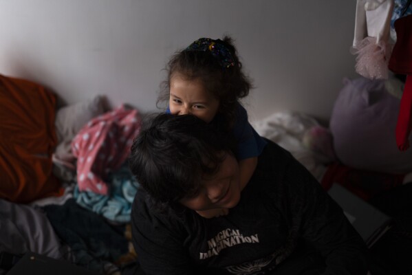 Deneffy Sánchez, 15, plays with his little sister, Jennifer, on a bunk bed they share in a shared studio apartment in Los Angeles, Saturday, Sept. 9, 2023. Like Deneffy, more than a quarter of U.S. students have missed at least 10 percent of the school year since schools reopened making it harder for them to catch up after the pandemic. In Los Angeles, housing insecurity is one of the biggest reasons kids have missed school. (AP Photo/Jae C. Hong)