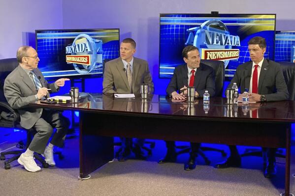 At a television studio in Reno, Nevada, Republican Senate hopefuls Sam Brown, right, and Adam Laxalt, second from right, prepare for a debate on Monday, May 9, 2022, taped for broadcast this week on "Nevada Newsmakers." The show is moderated by host Sam Shad, far left, and Victor Joecks, second from left, of the Las Vegas Review-Journal. Both candidates for the seat held by Sen. Catherine Cortez Masto, D-Nev., are U.S. military veterans. (AP Photo/Scott Sonner)