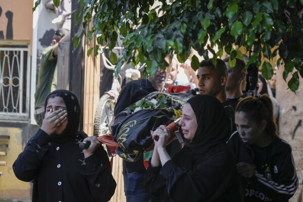 The classmates of 15-year-old Sadeel Naghniyeh carry her body during her funeral in the West Bank Jenin refugee camp, Wednesday, June 21, 2023, Naghniyeh died from wounds sustained in an Israeli military raid on Monday that triggered some of the fiercest fighting with Palestinian militants in years. (AP Photo/Majdi Mohammed)