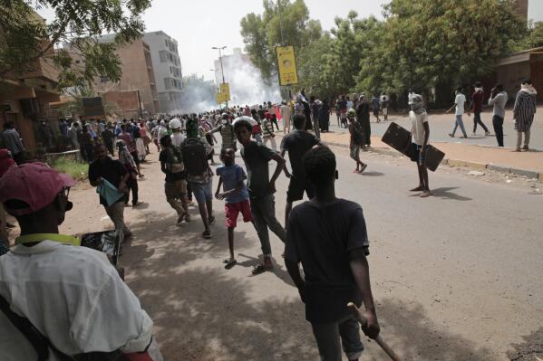 Protesters clash with security forces as they fire teargas to prevent them from marching towards the presidential palace during demonstrations demanding civilian rule, in Khartoum, Sudan, Thursday, May 19, 2022. (AP Photo/Marwan Ali)