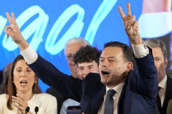 Luis Montenegro, leader of the center-right Democratic Alliance, gestures to supporters after claiming victory in Portugal's election, in Lisbon, Monday, March 11, 2024. AP Photo/Armando Franca)