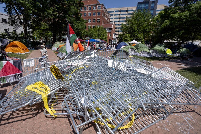 Barricades torn down by demonstrators are piled in the center of an encampment by students protesting against the Israel-Hamas war at George Washington University on Monday, April 29, 2024, in Washington. (AP Photo/Mark Schiefelbein)
