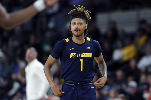 West Virginia's Noah Farrakhan takes the court during the first half of the team's NCAA college basketball game against UMass in the Basketball Hall of Fame Classic, Saturday, Dec. 16, 2023, in Springfield, Mass.(AP Photo/Michael Dwyer)