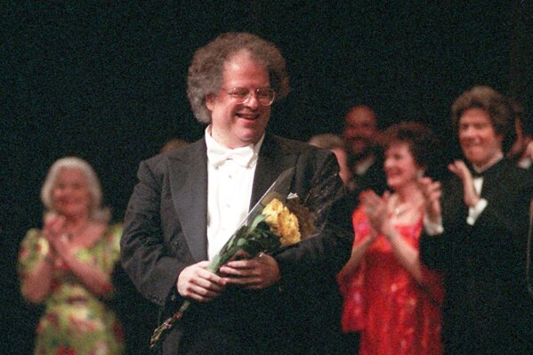 FILE - James Levine, center, the artistic director of the Metropolitan Opera, appears at a curtain call for the gala celebrating his 25th anniversary with the company in New York on April 28, 1996. Levine, who ruled over the Metropolitan Opera for 4 1/2 decades before being eased out when his health declined and then fired for sexual improprieties, died March 9, 2021 in Palm Springs, Calif., of natural causes, his physician of 17 years, Dr. Len Horovitz, said Wednesday, March 17. He was 77. (AP Photo/Osamu Honda, File)