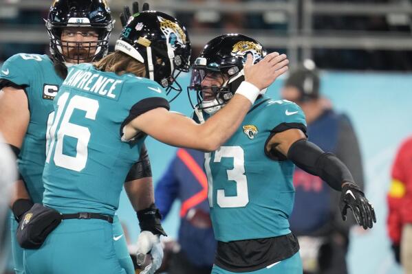 Jacksonville Jaguars wide receiver Christian Kirk (13) celebrates his touchdown reception with quarterback Trevor Lawrence (16) in the first half of an NFL football game against the Tennessee Titans, Saturday, Jan. 7, 2023, in Jacksonville, Fla. (AP Photo/John Raoux)