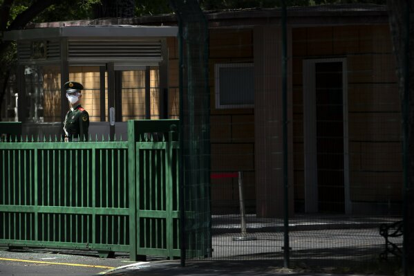 A Chinese paramilitary policeman wears a face mask and goggles as he stands guard outside the North Korean embassy in Beijing, Tuesday, April 21, 2020. The South Korean government said Tuesday no unusual activity has been detected in North Korea after unconfirmed reports described leader Kim Jong Un as in fragile condition after heart surgery. (AP Photo/Mark Schiefelbein)