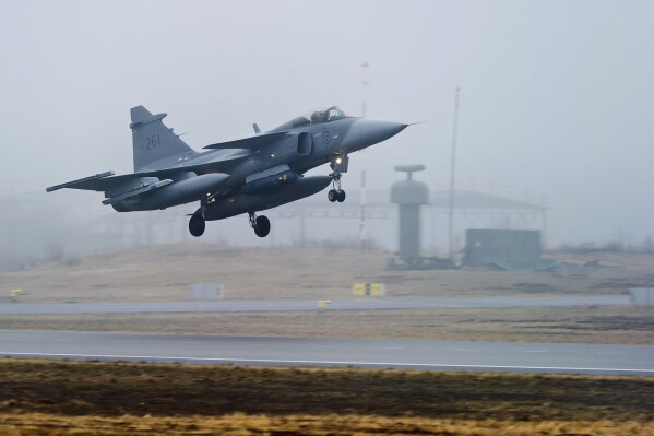 FILE - One of three Swedish Air Force JAS 39 Gripen fighter aircraft takes off from the Blekinge Wing F17, based in Kallinge southern Sweden for a base in Sardinia to join the Nato-led operation in Libya, on Saturday, April 2, 2011. As Sweden joins NATO, it bids a final farewell to more than two centuries of neutrality. (AP Photo/Scanpix/Patric Soderstrom, File)