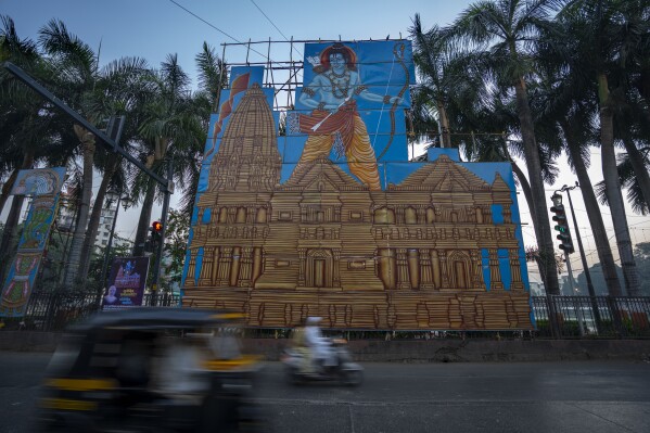 Vehicles drive past a billboard featuring Hindu deity Lord Ram and his temple in Mumbai, India, ahead of the opening of the grand temple in northern Ayodhya city, Wednesday, Jan. 17, 2024. (AP Photo/Rafiq Maqbool)