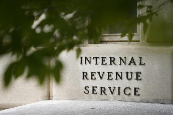 FILE - A sign is displayed outside the Internal Revenue Service building on May 4, 2021, in Washington. Taxpayers who called the IRS had an average wait time of four minutes this tax season compared to 27 minutes a year earlier, the agency said Monday, April 17, 2023. (AP Photo/Patrick Semansky, File)