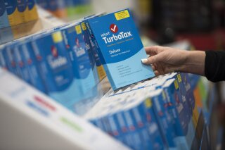 FILE - In this April 18, 2016 file photo a person looks at Intuit TurboTax software on display at a retailer in Foster City, Calif. Intuit announced Monday, Feb. 24, 2020, that it is buying consumer finance company Credit Karma in a $7.1 billion cash and stock deal. (Peter Barreras/AP Images for Turbo Tax Via AP, File)