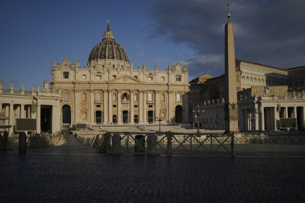 The morning sun shines on the St. Peter's Basilica with the Sistine Chapel at background right, where the cardinals elect a new pope during the conclave at the Vatican, Thursday, May 8, 2025. (AP Photo/Markus Schreiber)