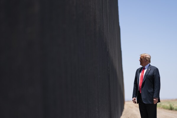 FILE - In this June 23, 2020, file photo, President Donald Trump tours a section of the border wall in San Luis, Ariz. Wisconsin is dropping out of two multistate lawsuits that challenged Trump’s decision to divert billions of dollars to fund a wall across the southern U.S. border. Lawmakers in Wisconsin granted the state Justice Department permission to exit the lawsuits on Tuesday, July 25, 2023. (AP Photo/Evan Vucci, File)