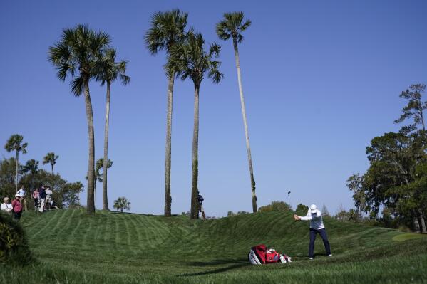 Scottie Scheffler hits towards the fifth green during a practice round for The Players Championship golf tournament Wednesday, March 8, 2023, in Ponte Vedra Beach, Fla. (AP Photo/Charlie Neibergall)