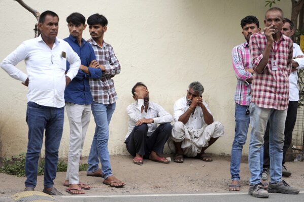 The family is waiting at the hospital for the remains of a relative who was killed in a plane crash on Thursday in Ahmedabad, India on Friday, June 13, 2025 (AP Photo/Ajit Solanki)