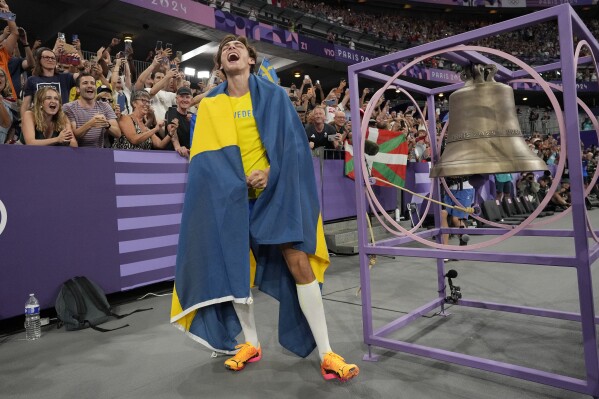 Armand Duplantis, of Sweden, reacts after setting a new world record in the men's pole vault final at the 2024 Summer Olympics, Monday, Aug. 5, 2024, in Saint-Denis, France. (AP Photo/Bernat Armangue)