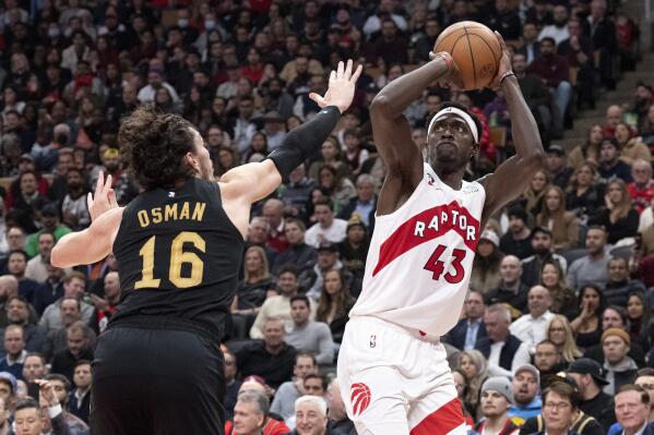Toronto Raptors' Pascal Siakam (43), right, scores on Cleveland Cavaliers' Cedi Osman (16) during the first half of an NBA basketball game in Toronto, Monday, Nov. 28, 2022. (Chris Young/The Canadian Press via AP)